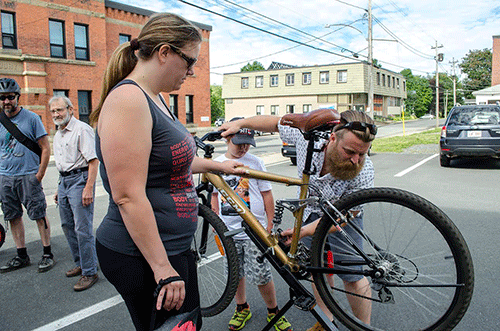 Don’t be afraid to enlist the help and expertise of friends, family -- even exes. Photo credit: Brendan Helmuth. Man working on a bicycle while a woman looks on