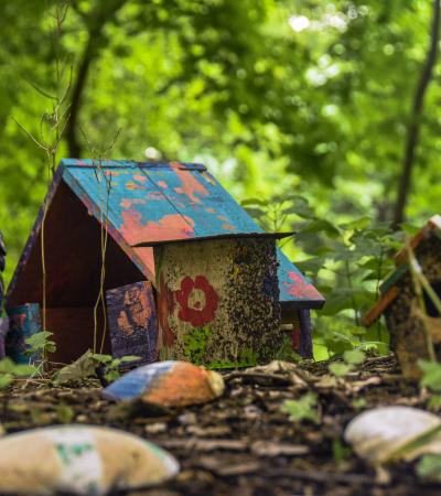 miniature painted "gnome house" in the woods