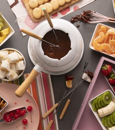 chocolate fondue dessert bar with cookies marshmallows and a variety of fruit