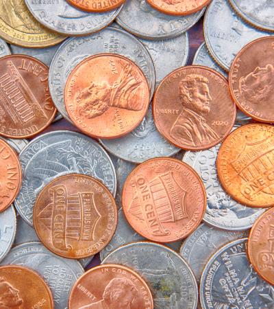 currency spread of coins (quarters, dimes, nickels and pennies)