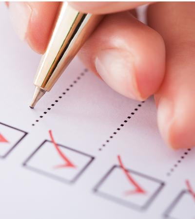 pen checking off items on a checklist