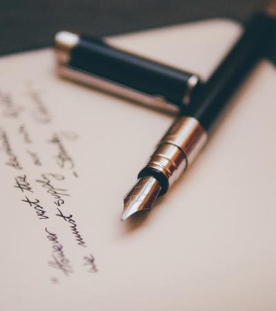 National Poetry Month Pen on paper with writing