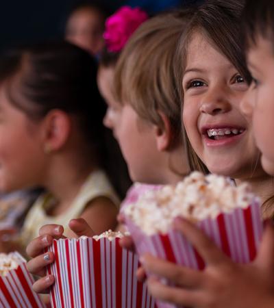 kids watching a movie with popcorn kids watching a movie with popcorn