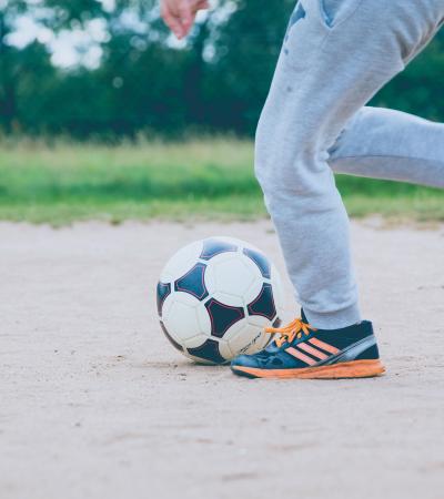 Child kicking soccer ball
