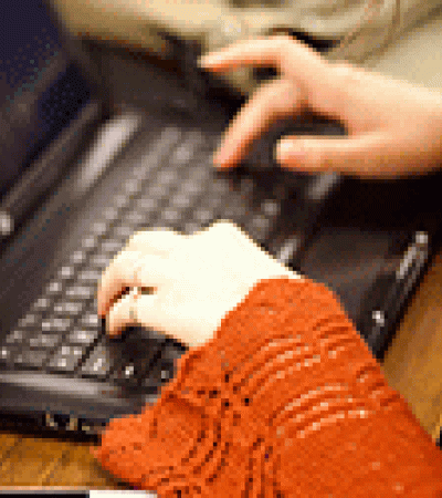 Close-up of hands typing on a laptop Close-up of hands typing on a laptop