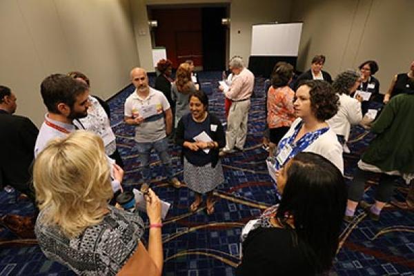 Librarians standing in a circle at a workshop at the ALA Annual Conference. 