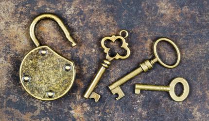 vintage keys and padlock on a rusty metal background