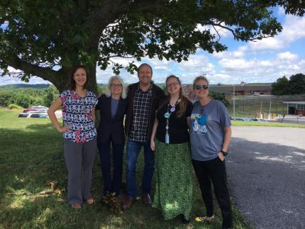 Librarians pose with author Jay Asher.