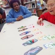 Participants playing a board game  Participants playing a board game