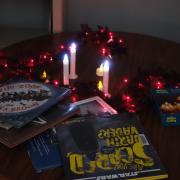 Photograph of storytime books on a table with candles and Halloween decorations.