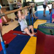 Child playing on gymnastics equipment 