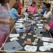 The participants use stamps to decorate linen gift bags. The participants use stamps to decorate linen gift bags.