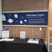 Photograph of the full 1000 Paper Cranes display table