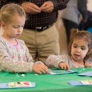 Girls making a craft at a Light Up the Holidays program Girls making a craft at a Light Up the Holidays program
