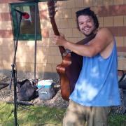 Musician playing guitar at the Farmers Market Musician playing guitar at the Farmers Market