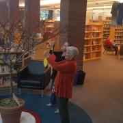 Patrons hang paper leaves on the Poet-tree Patrons hang paper leaves on the Poet-tree