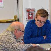 One-on-one Teen Tech Tutoring  Teen and older man using a tablet