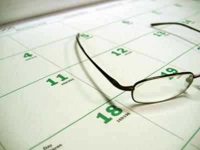 Calendar with glasses atop it