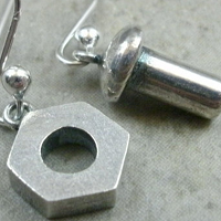 close-up of earrings made with nuts and bolts