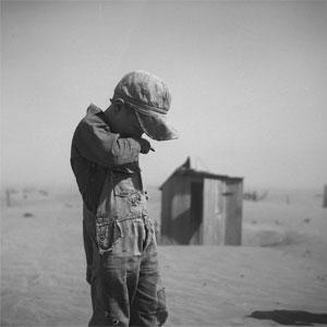 A young boy covers his mouth during a dust storm on farm. Cimarron County, Oklahoma. April 1936.  Arthur Rothstein; The Library of Congress, Prints & Photographs Division