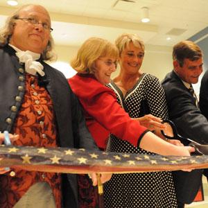 Ribbon cutting for the opening of the “Benjamin Franklin: In Search of a Better World” traveling exhibition with Ben Franklin (Christopher Lowell); Julie McDaniel, and Sherry and Greg Stocksdale.