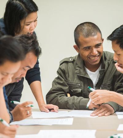 Experts from ASIA Inc. teach financial literacy to a Nepali-speaking man. Experts from ASIA Inc. teach financial literacy to a Nepali-speaking man.
