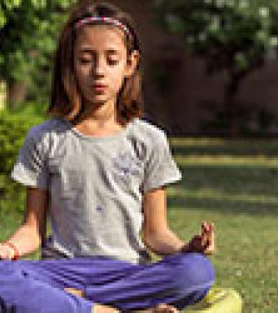 Young girl meditating outdoors Young girl meditating outdoors