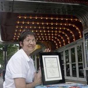 Nicolette Vaillancourt with the Jaffarian Award plaque, under the lights of the York Theater in Elmhurst, Ill. Sarah Minor